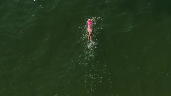 Woman Swimming On Back In Sea