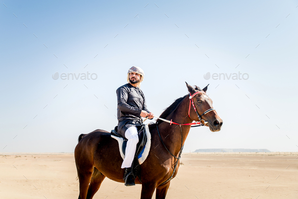 Arabian man with horse in the desert