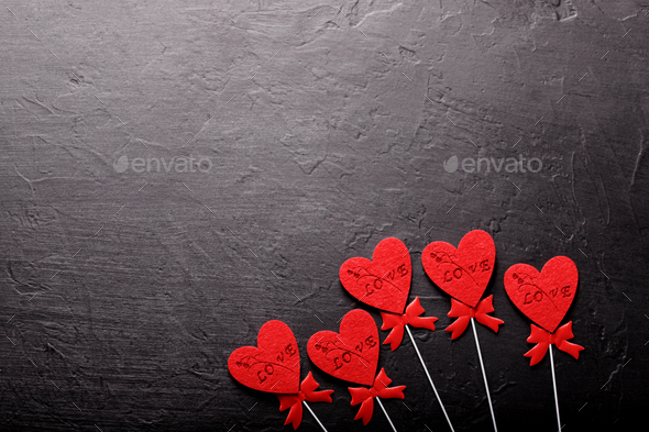 Beautiful valentines day background with red hearts on black background.  Stock Photo by Sepaolina