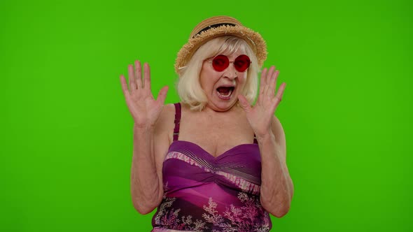 Scared Senior Woman Tourist Stretching Out Hands Stop Gesture to Hide From Fear Looking Afraid alt