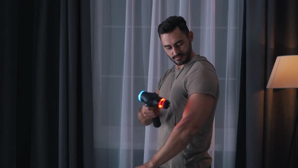Man Uses Massager at Home