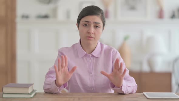 Indian Woman Talking on Video Call while Sitting in Office alt