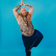 Funny fat man doing yoga meditation Stock Photo by