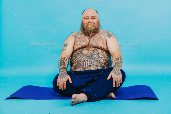 Funny fat man doing yoga meditation Stock Photo by oneinchpunchphotos
