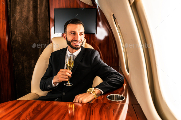 Businessman flying on private jet - Stock Photo - Images