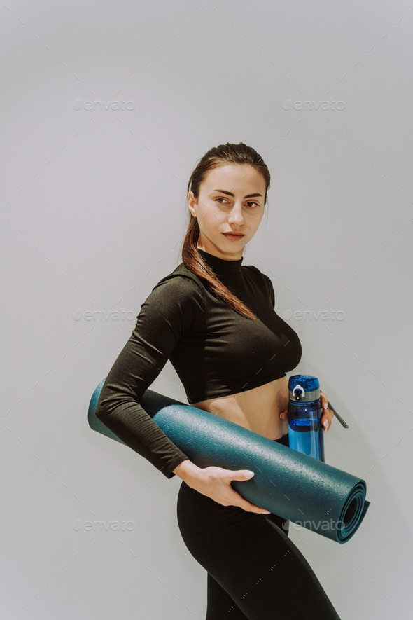Beautiful Athletic Woman Training In A Gym, Doing Stretching