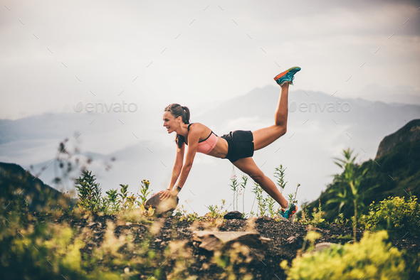 Fitness woman doing exercises in nature. Stock Photo by korneevamaha