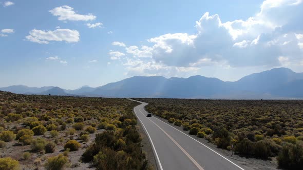 Aerial View of Asphalt Road in the Middle of Dusty Dry Desert Land in Lee Vining alt