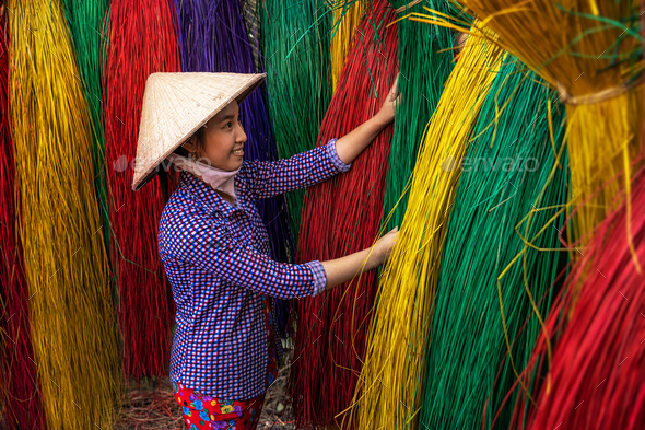 Old Vietnamese female craftsman making the traditional bamboo fish trap or  weave Stock Photo by thananit_s