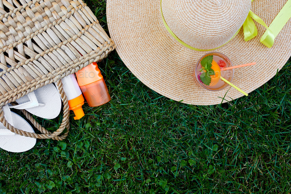 Flat lay of outdoor bright summer beach vacation or travel lifestyle concept on grass background - Stock Photo - Images
