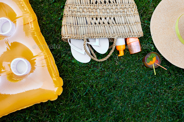 Flat lay of outdoor bright summer beach vacation or travel lifestyle concept on grass background - Stock Photo - Images