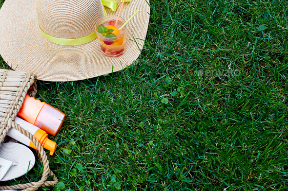 Flat lay of outdoor bright summer beach vacation or travel lifestyle concept on grass background - Stock Photo - Images