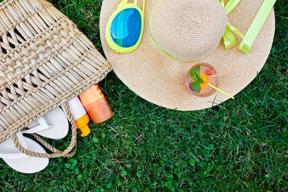 Flat lay of outdoor bright summer beach vacation or travel lifestyle concept on grass background - Stock Photo - Images