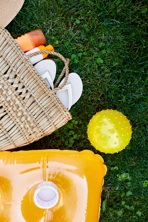 Flat lay of outdoor bright summer beach vacation or travel lifestyle concept on grass background - Stock Photo - Images