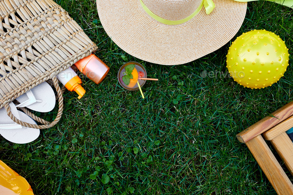 Flat lay of outdoor bright summer beach vacation or travel lifestyle concept on grass background - Stock Photo - Images