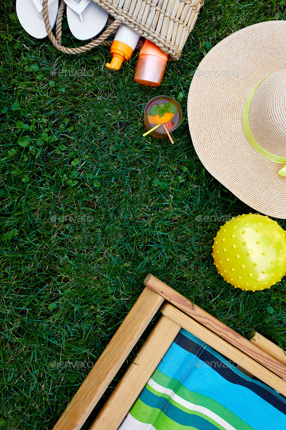 Flat lay of outdoor bright summer beach vacation or travel lifestyle concept on grass background - Stock Photo - Images