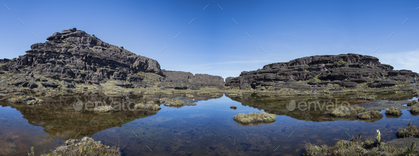 Summit of Mount Roraima, small lake and volcanic black stones with their reflection in the water. - Stock Photo - Images