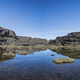 Summit of Mount Roraima, small lake and volcanic black stones with their reflection in the water. - PhotoDune Item for Sale
