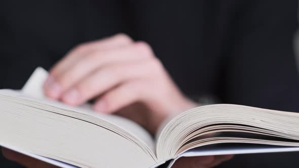 Reading a Book and Turning the Pages Close Up Slow Motion alt
