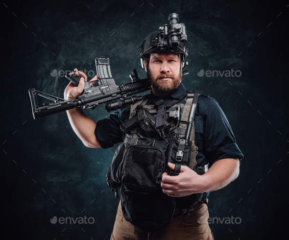 Combative man poses in dark background with rifle looking at camera Stock  Photo by fxquadro