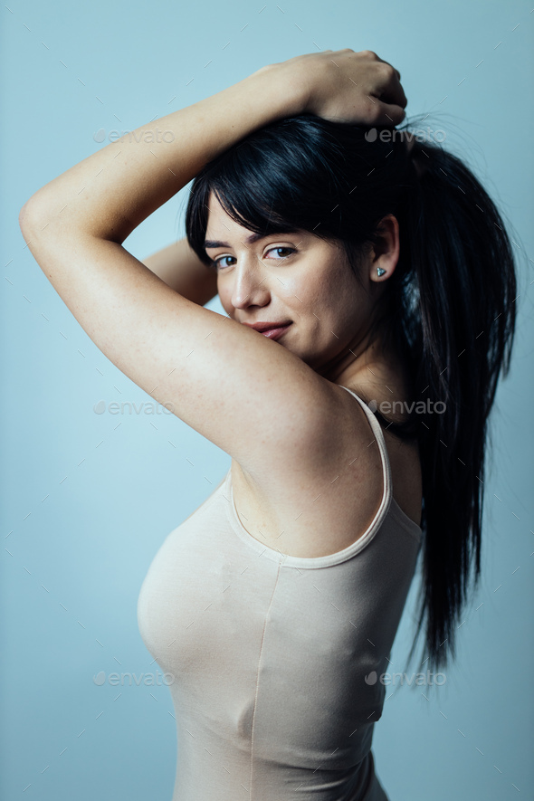 Beautiful girl posing in studio for a body positivity photo session Stock  Photo by oneinchpunchphotos