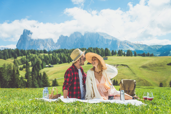 Happy couple on vacation on the italian dolomites mountains.