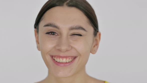 Face of Spanish Woman Winking at the Camera alt