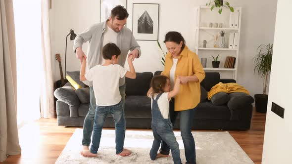 Overjoyed Cheerful Energetic Family Have a Fun in Cozy Living Room