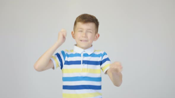 Cute Boy Dancing Fun in the Studio on a White Background alt