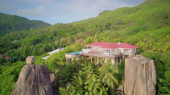 Villa with palm tree and rocks aerial view at Seychelles