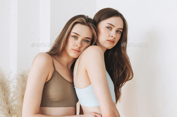 Sisters twins beautiful girls with long hair in sport seamless ribbed  underwear Stock Photo by GalinkaZhi