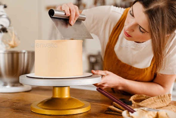 Beautiful Concentrated Pastry Chef Woman Making Cake With Cream Stock Photo By Vadymvdrobot