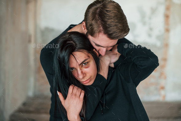 Kidnapped woman is threatened by man in abandoned building Stock Photo ...