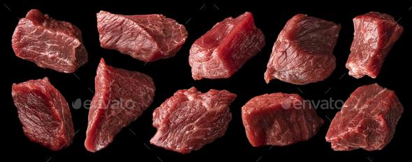 Cubes of raw beef isolated on black background