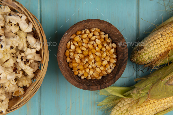 top view of organic corn kernels on a wooden bowl with corns with