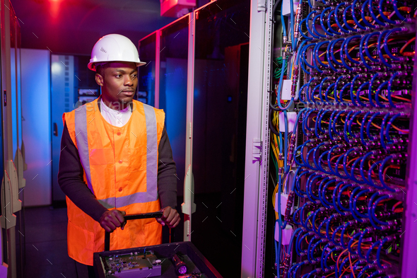 Data center electrician pushing cart with tools