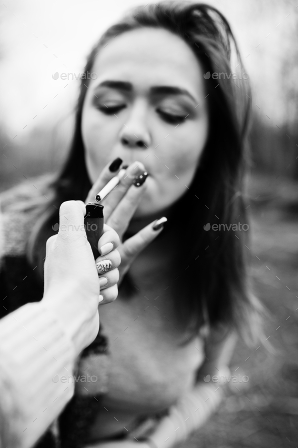 Hand of girl with cigarette lighter. Stop smoking social problem