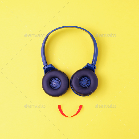 Headphones on a yellow background in the form of a happy face with a smile - Stock Photo - Images