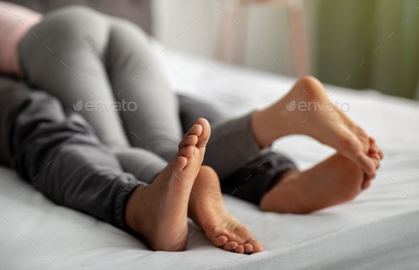 Barefoot Interracial Porn - Closeup view of young interracial lovers feeling sexual desire, making out  on bed at home, copy Stock Photo by Prostock-studio