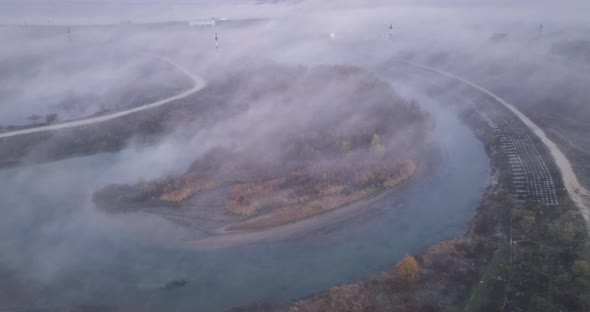 Cinematic Aerial View of Sunrise with Fog Above a Lake in Romania