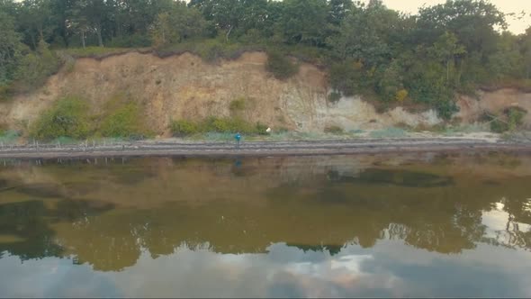 Aerial view of a beach with quiet water alt