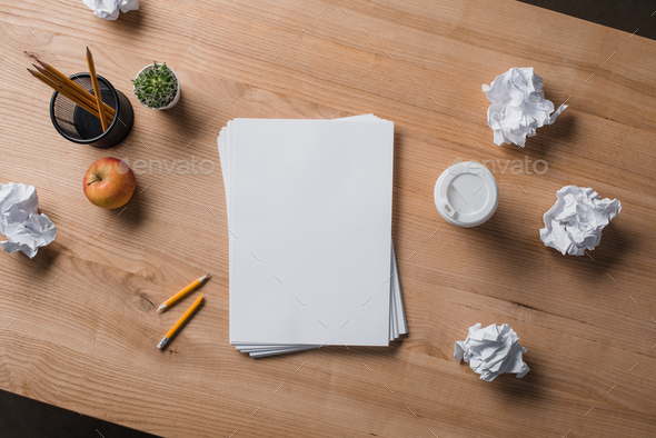 view from above of blank white paper on wooden table Stock Photo by  LightFieldStudios