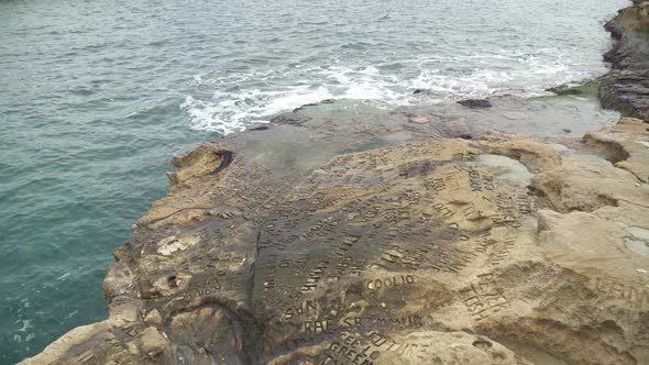 Names and Letters Carved into St Peters Pool Stone Beach Ground alt