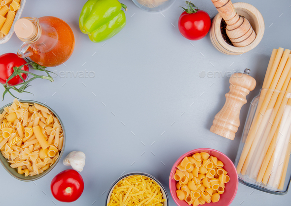 top view of different types of macaroni as tagliatelle, ziti, pipe-rigate, bucatini with tomato