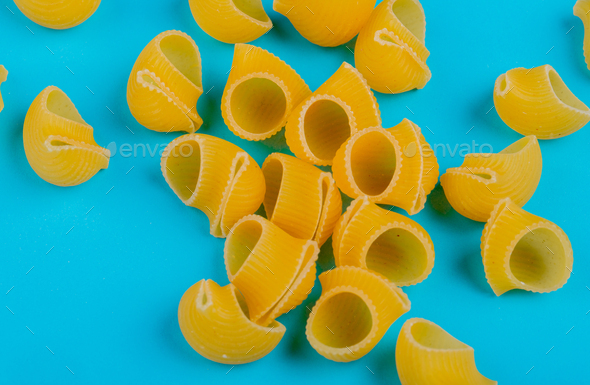 side view of pipette-rigate pasta on blue background Stock Photo by  stoockking