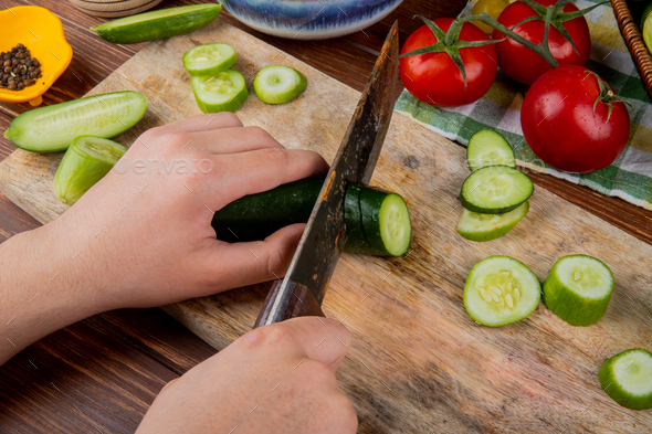 https://s3.envato.com/files/334826526/side%20view%20of%20woman%20hands%20cutting%20cucumber%20with%20knife%20on%20cutting%20board%20with%20tomatoes%20black%20pepper%20on%20wooden%20background.jpg