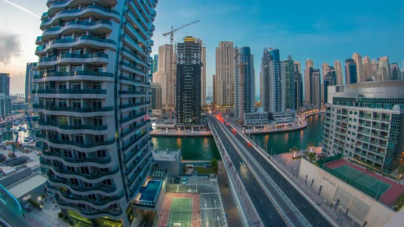 An Aerial View of Dubai Marina Towers in Dubai Day to Night Timelapse alt