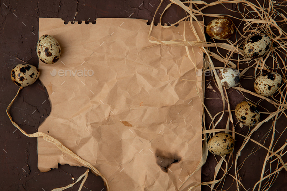 close-up view of mini eggs with straw on maroon background with copy space