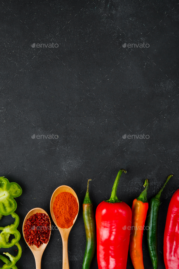 Spices in spoons on black background.