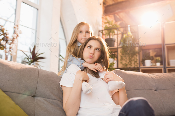 Family time. Mother and daughter having time together at home, look happy and sincere - Stock Photo - Images